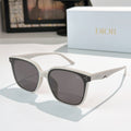 White cat-eye sunglasses with dark lenses and small star-like accents on temples
