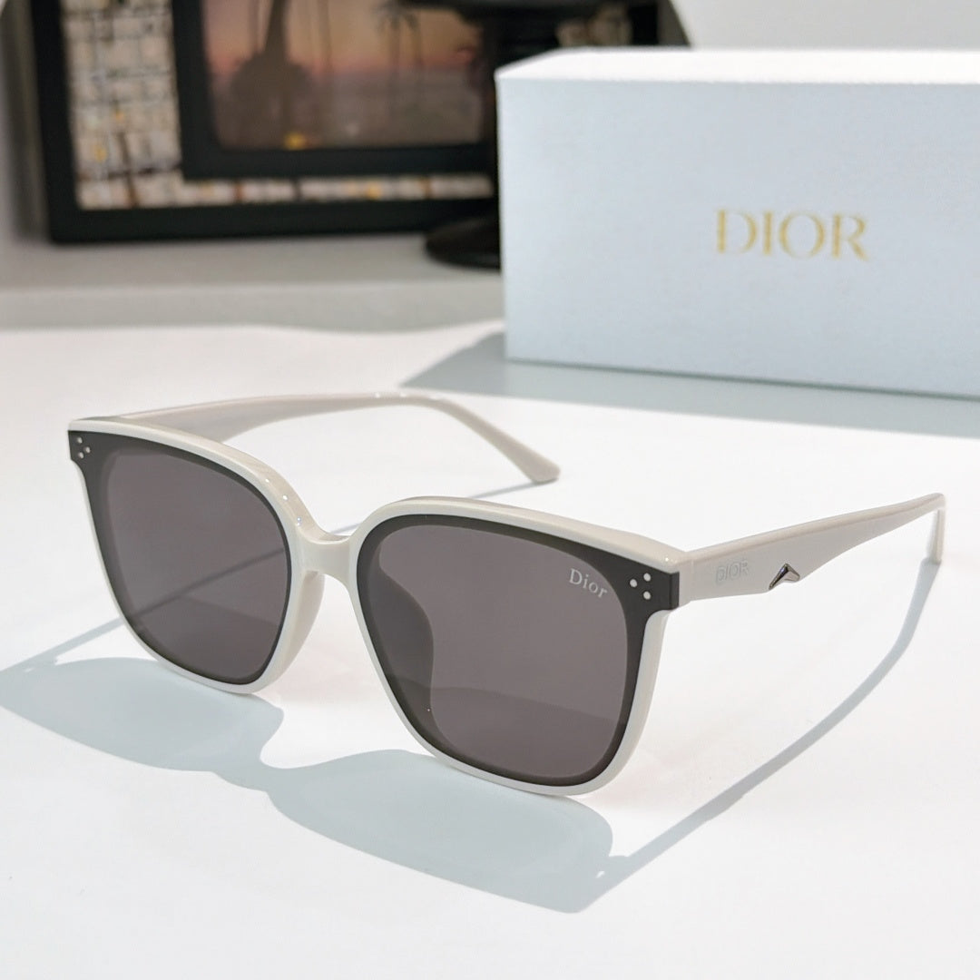 White cat-eye sunglasses with dark lenses and small star-like accents on temples