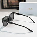 Black sunglasses with dark lenses and slim arms, logo near the hinge