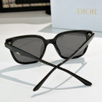 Black cat-eye sunglasses with dark lenses and star-like metal detail at the temple