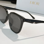 Black sunglasses with dark lenses, Dior logo on temple, and star-shaped metal detail