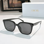 Black sunglasses with dark lenses and star-like metal detail near the temples