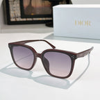 Dark brown sunglasses with gradient mauve lenses and star-like temple accents