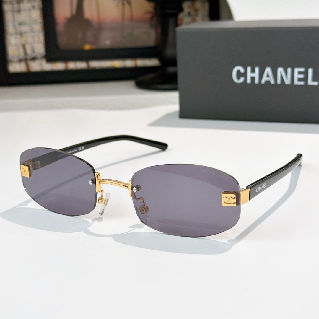 Chanel glasses with dark purple lenses, gold details and black temples
