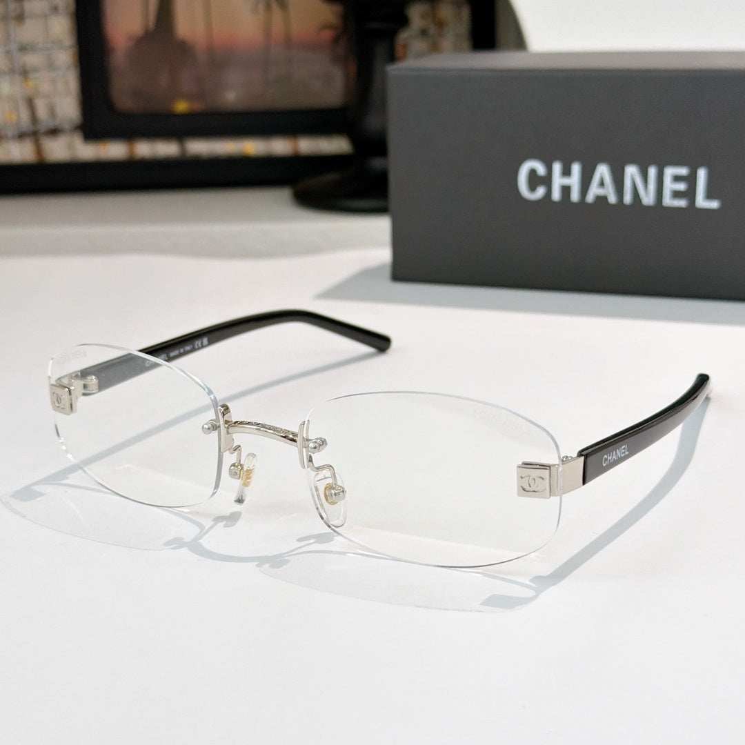 Chanel glasses with clear lenses, gold metal frame and black temples