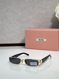 MiuMiu gold eyeglass frame with black temples and dark lenses