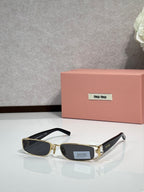 MiuMiu gold eyeglass frame with black temples and dark lenses