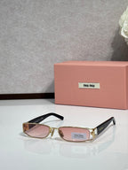 MiuMiu gold eyeglass frame with black temples and pink-tinted lenses