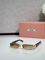 MiuMiu gold eyeglass frame with black temples and olive lenses