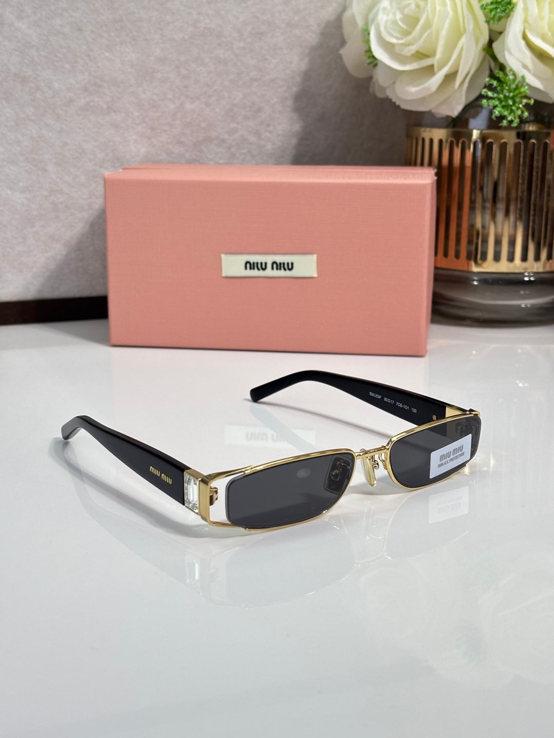 MiuMiu gold eyeglasses with black lenses and black temples