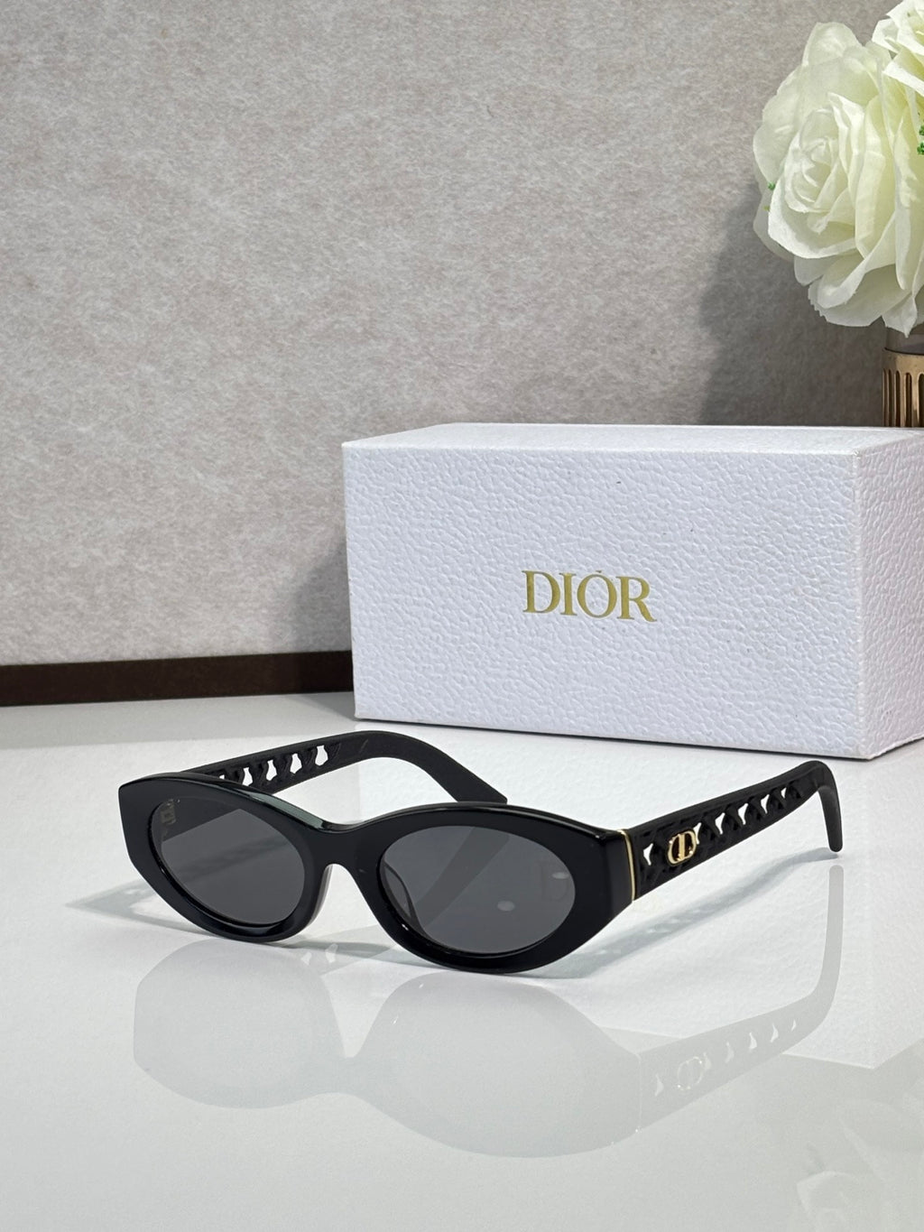 Dior sunglasses with black oval frames and dark lenses