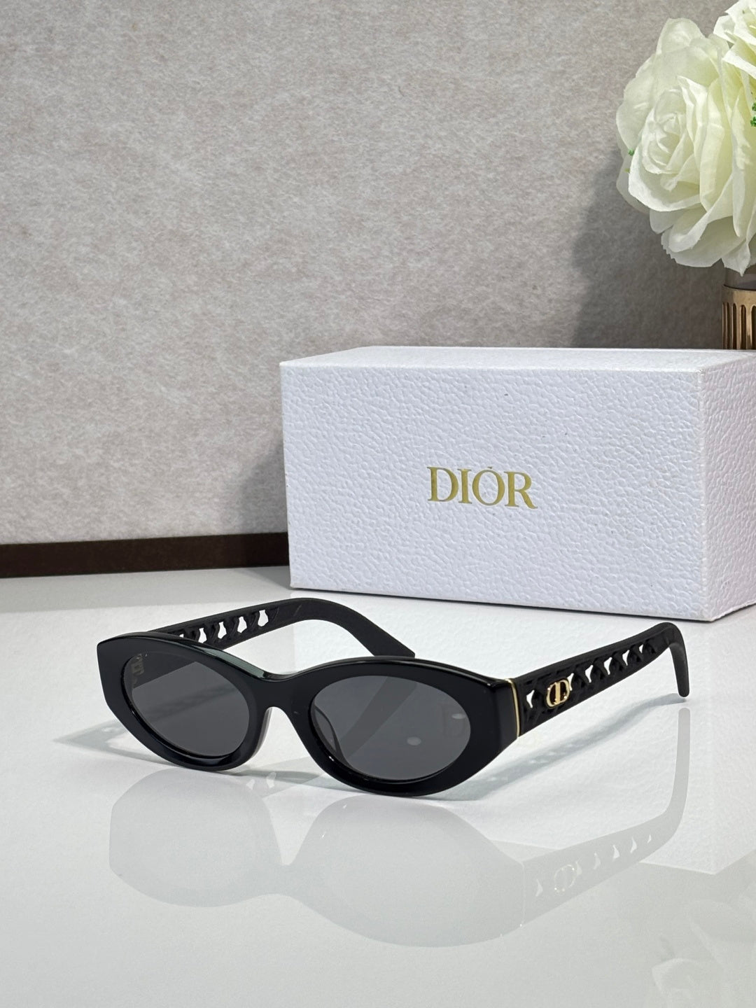Dior sunglasses with black oval frames and dark lenses