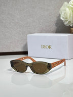 Dior sunglasses with tan-brown oval frames and dark lenses