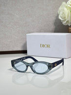 Dior sunglasses with blue-gray oval frames and tinted lenses