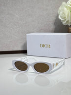 Dior sunglasses with white oval frames and dark lenses