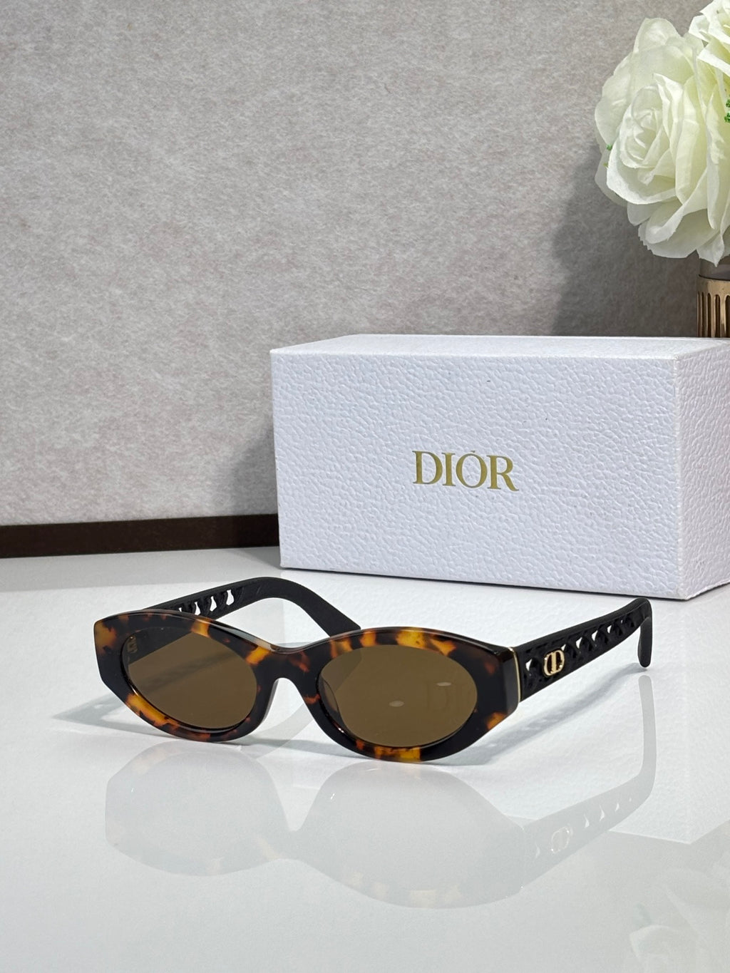 Dior sunglasses with dark tortoiseshell frames and brown tinted lenses