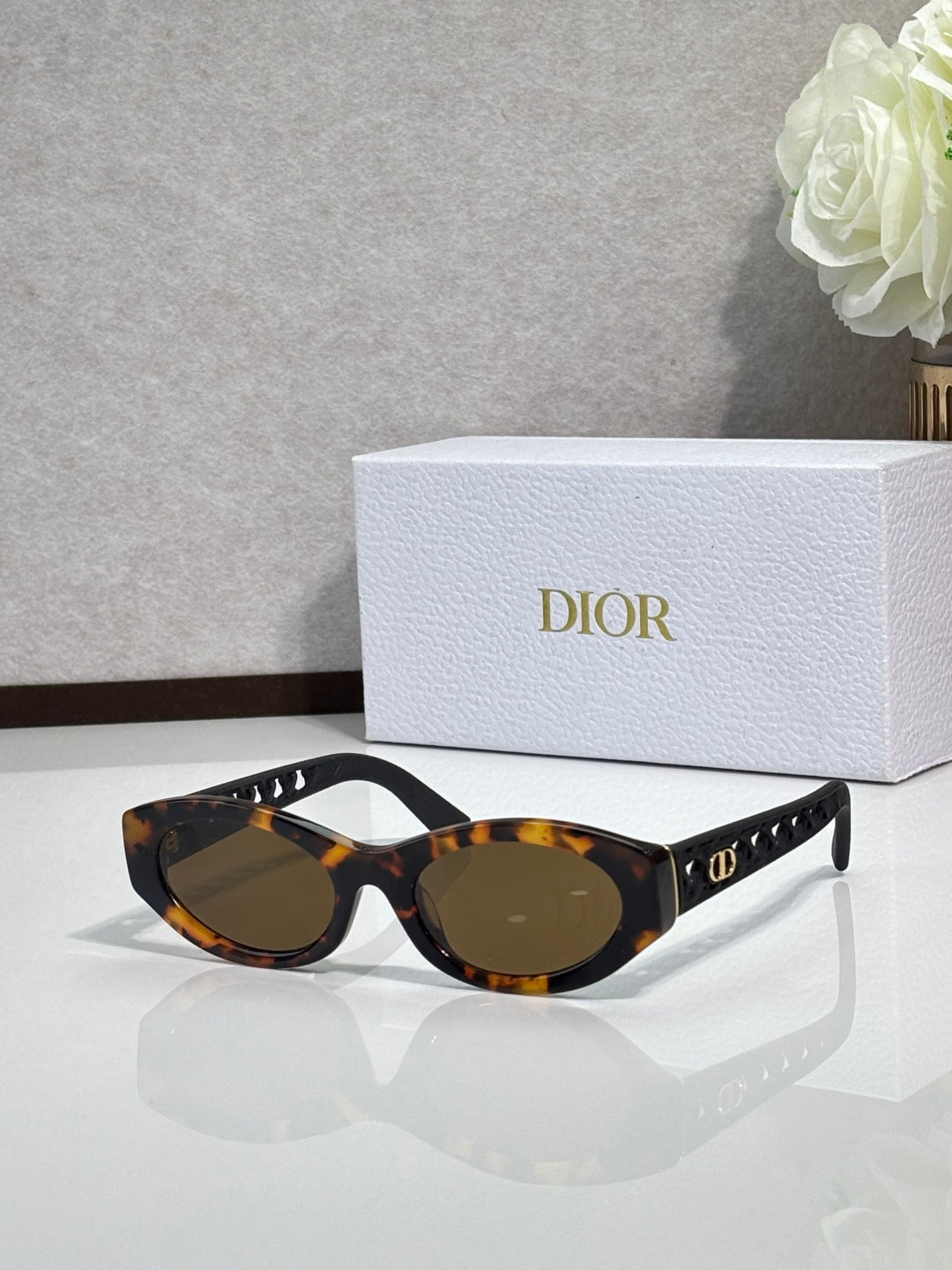 Dior sunglasses with dark tortoiseshell frames and brown tinted lenses