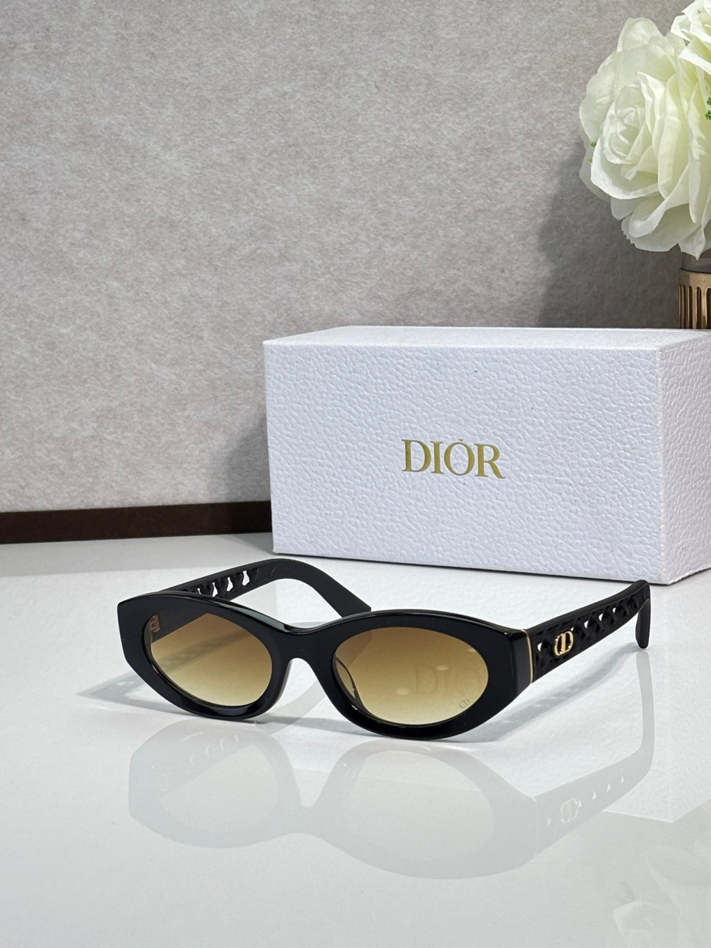 Dior sunglasses with tortoiseshell-style frames and brown tinted lenses