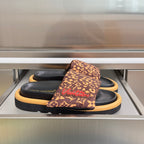 Louis Vuitton sandals: brown monogram strap, black footbed, tan platform sole