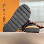 Louis Vuitton sandals with black treaded outsole and tan platform edge