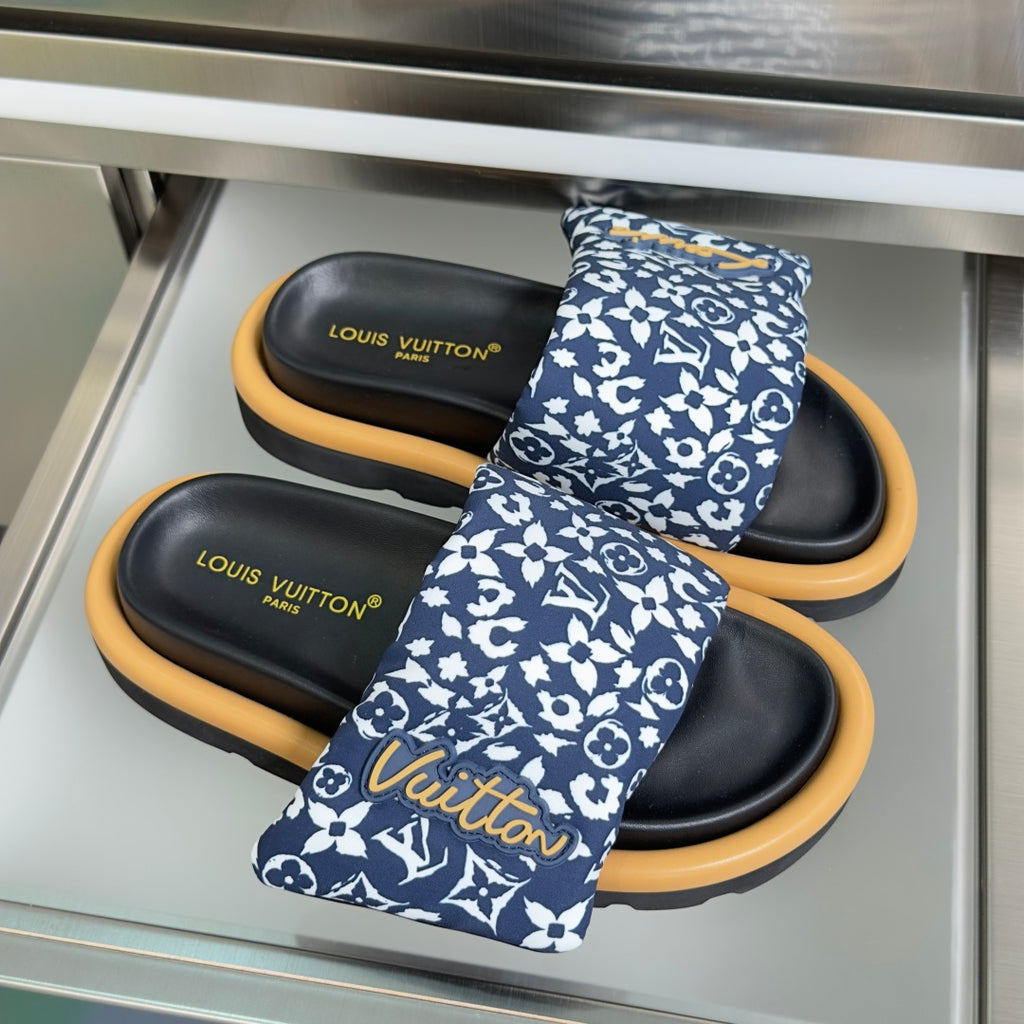 Louis Vuitton sandals pair with blue patterned crossing strap and black footbeds, tan soles