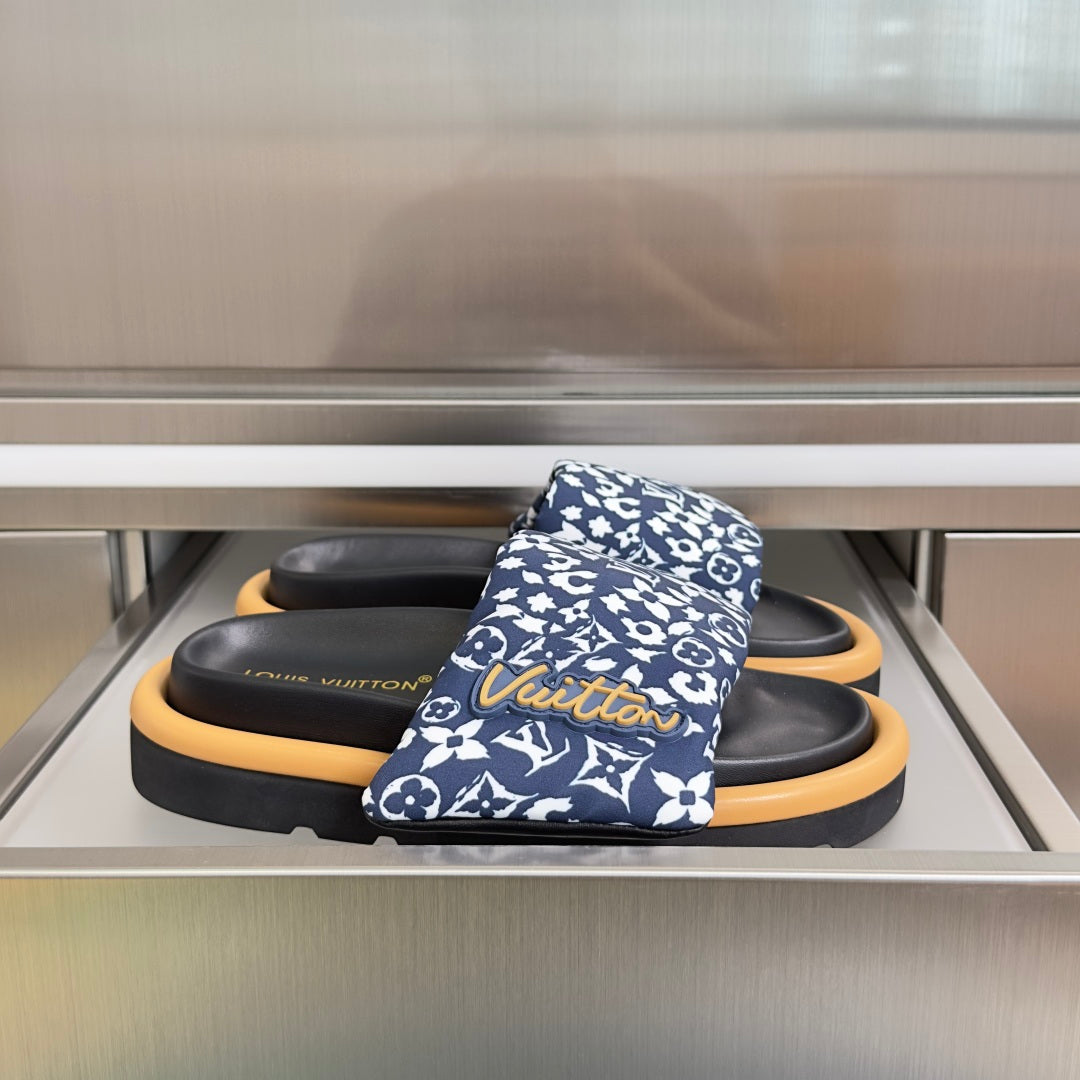 Louis Vuitton slide sandals with blue patterned straps and black footbeds, tan rubber soles