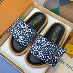 Louis Vuitton slide sandals in a box: blue patterned straps, black footbeds, tan rubber soles