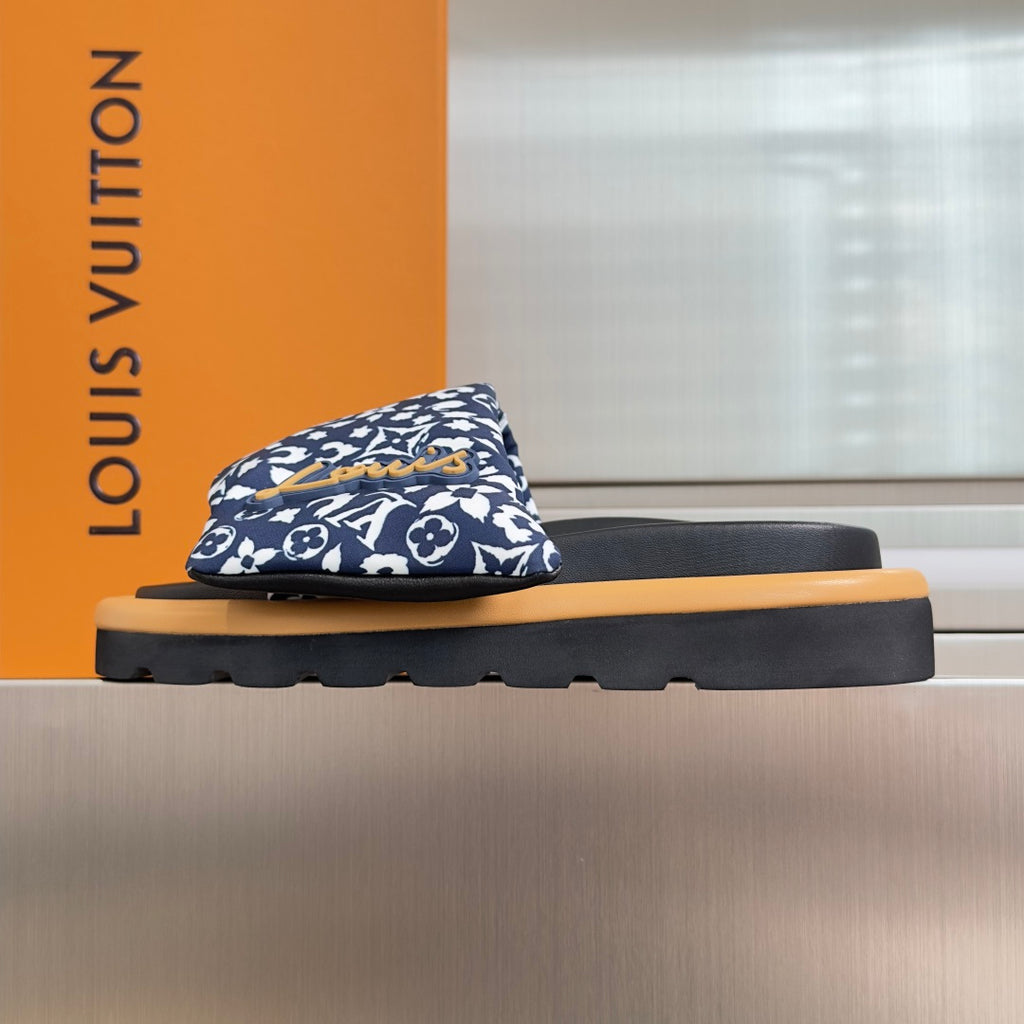 Louis Vuitton slide sandal with blue floral monogram strap and black base, tan rubber sole