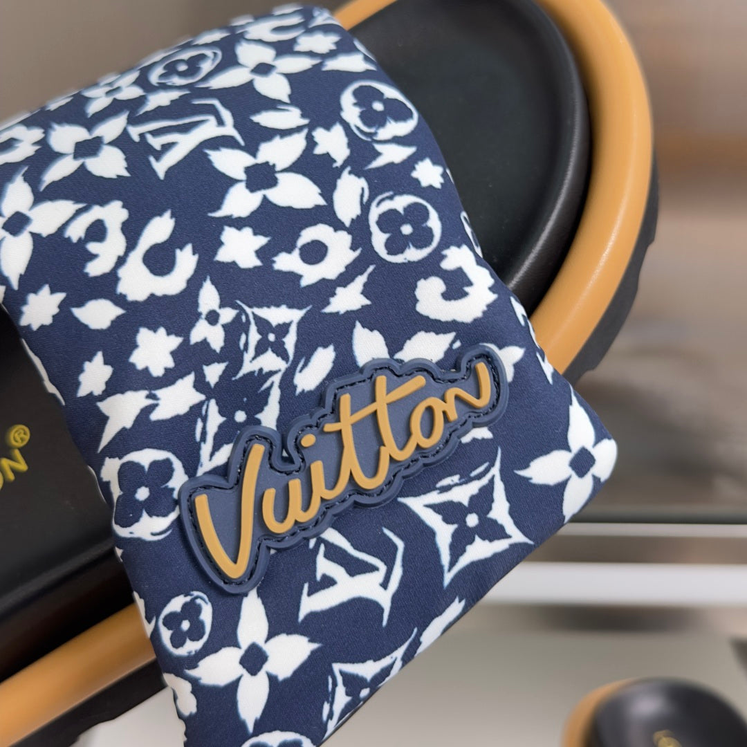 Louis Vuitton strap close-up: navy fabric with white floral pattern and gold-tone stitched lettering