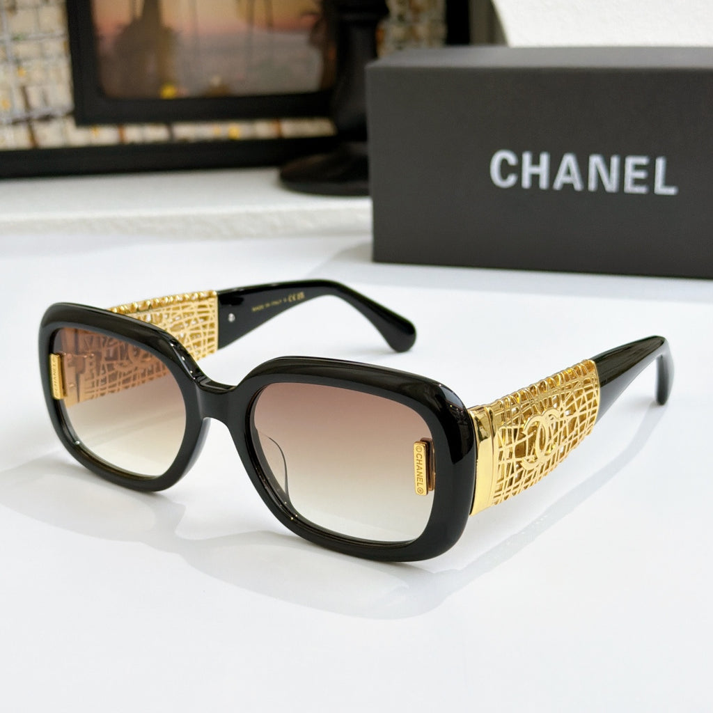 Chanel glasses with black frame, gold patterned temples, and warm brown lenses