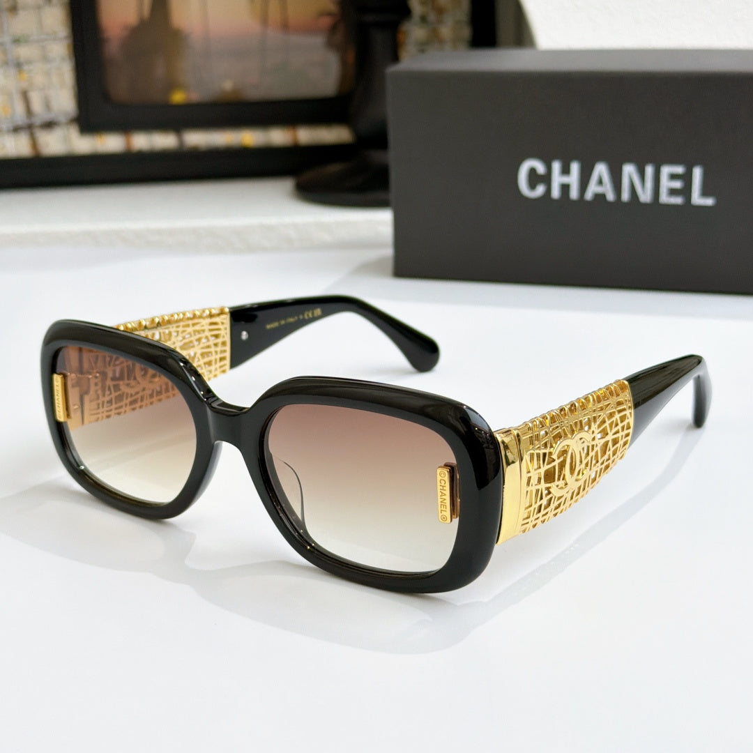 Chanel glasses with black frame, gold patterned temples, and warm brown lenses