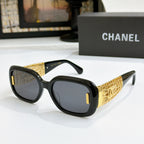 Chanel glasses with black frame, gold patterned temples, and dark lenses