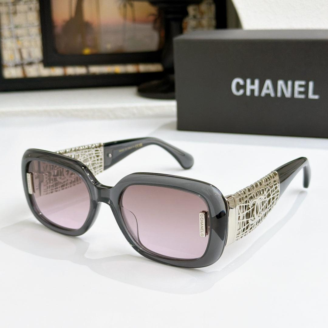 Chanel glasses with charcoal frame, gold patterned temples, and purple-tinted lenses