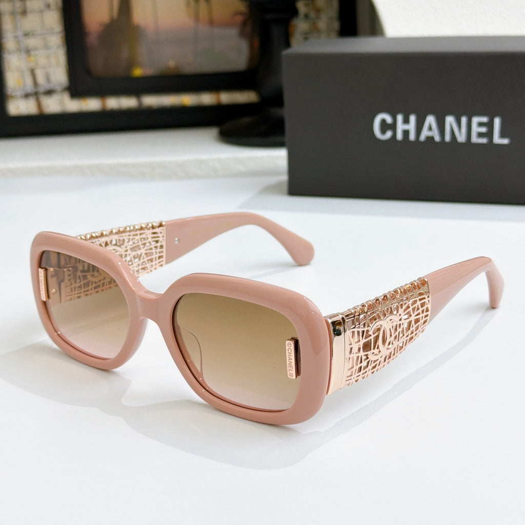 Chanel glasses with blush pink frame, gold patterned temples, and tan lenses