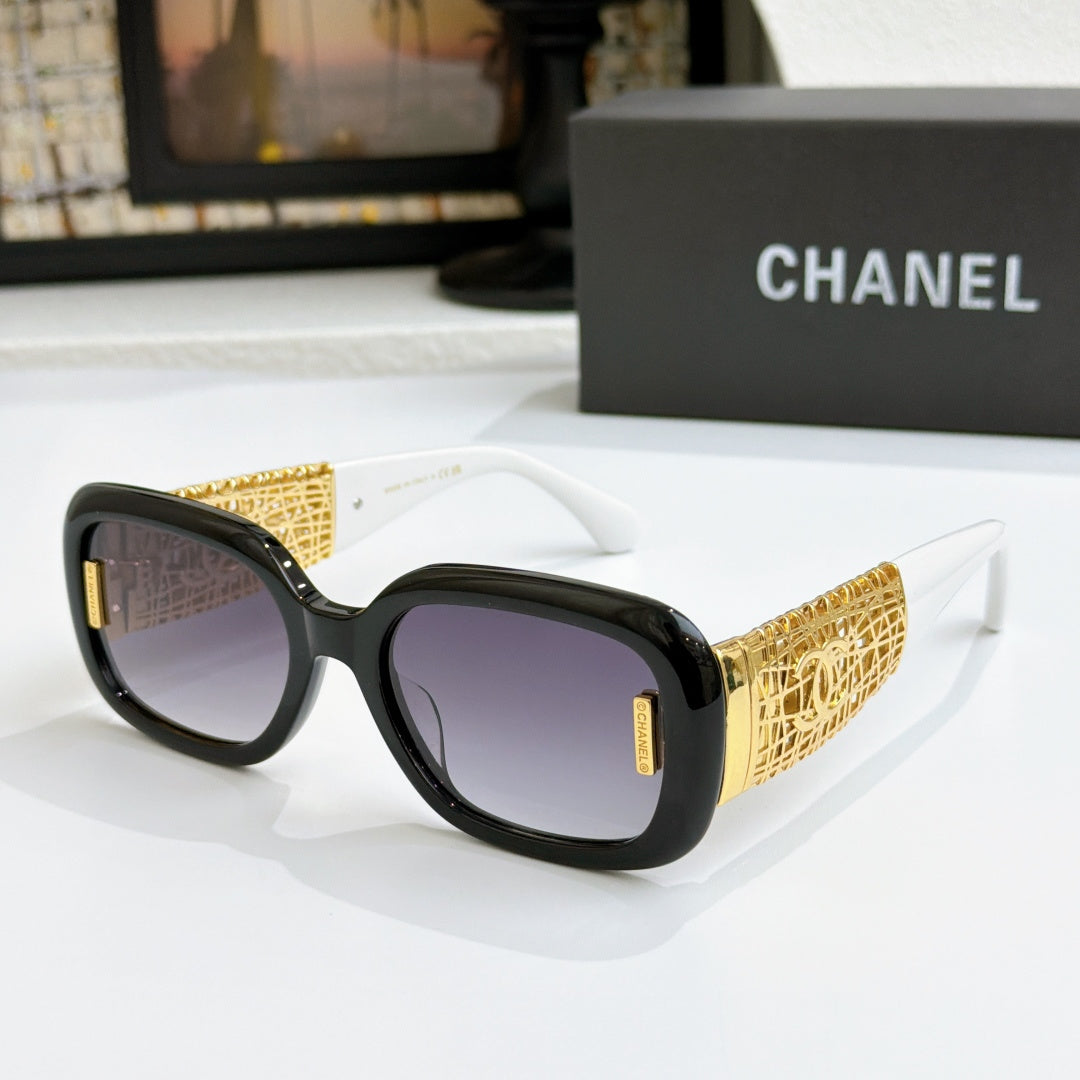 Chanel glasses with black frame, gold patterned temples, and light purple lenses