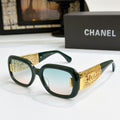 Chanel glasses with dark green frame, gold patterned temples, and light blue lenses