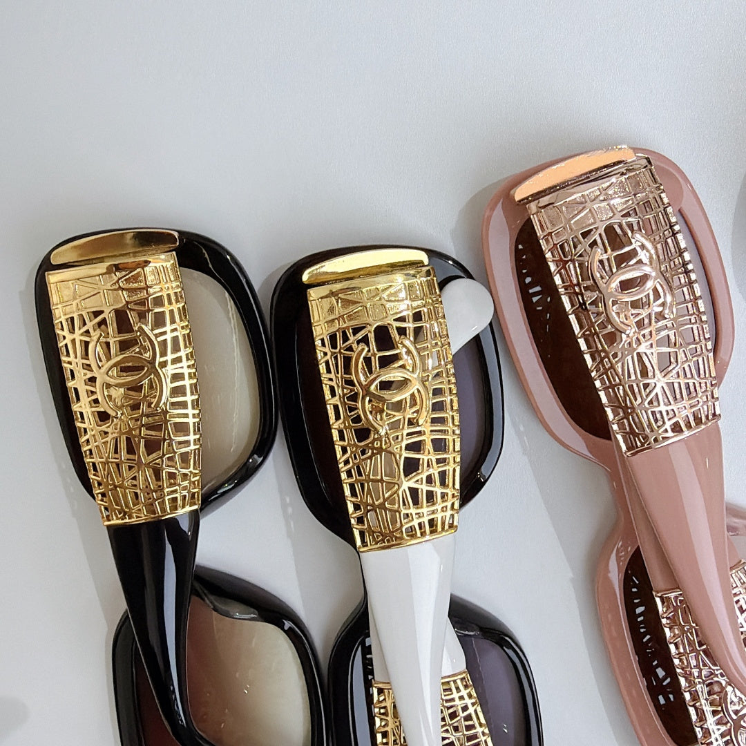 Chanel glasses close-up of gold patterned temples on black and blush frames