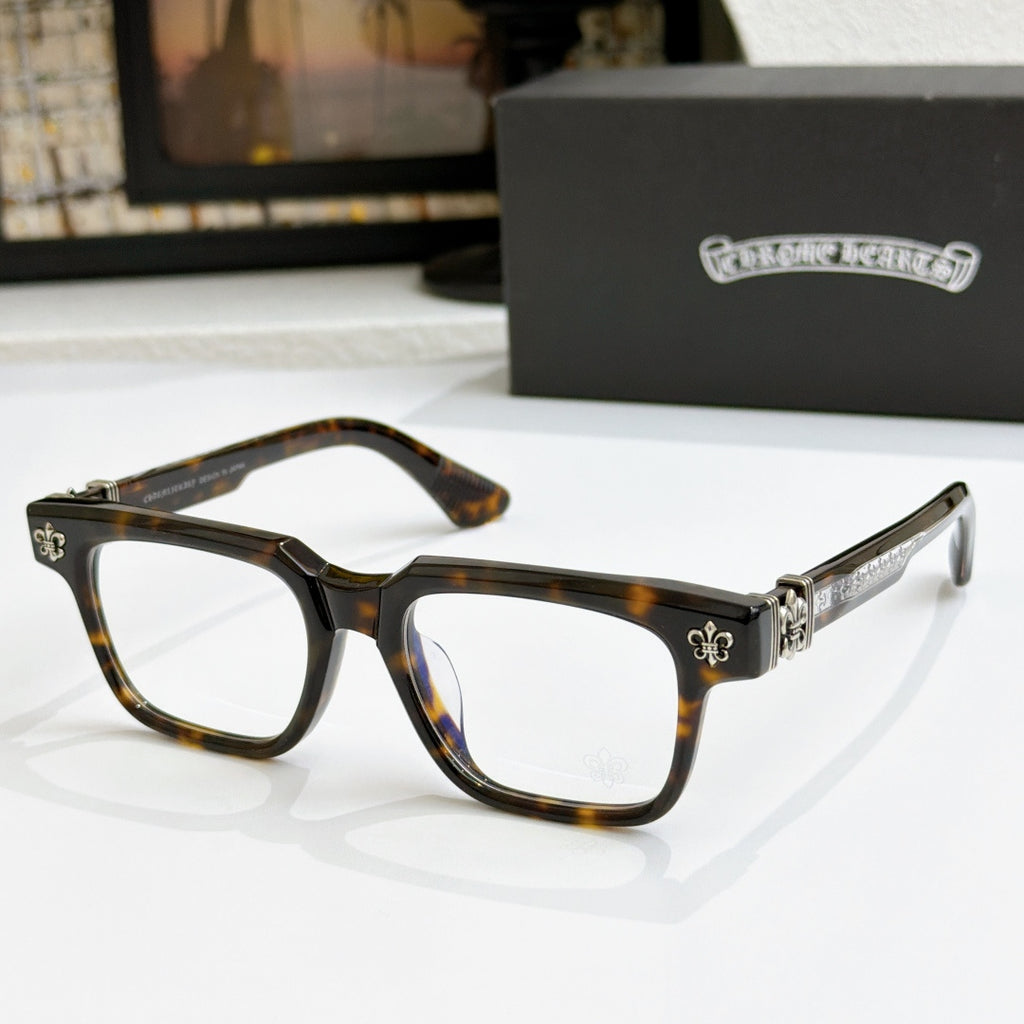 Tortoise shell frame chrome eyeglasses with gold-tone arms and fleur-de-lis hinge