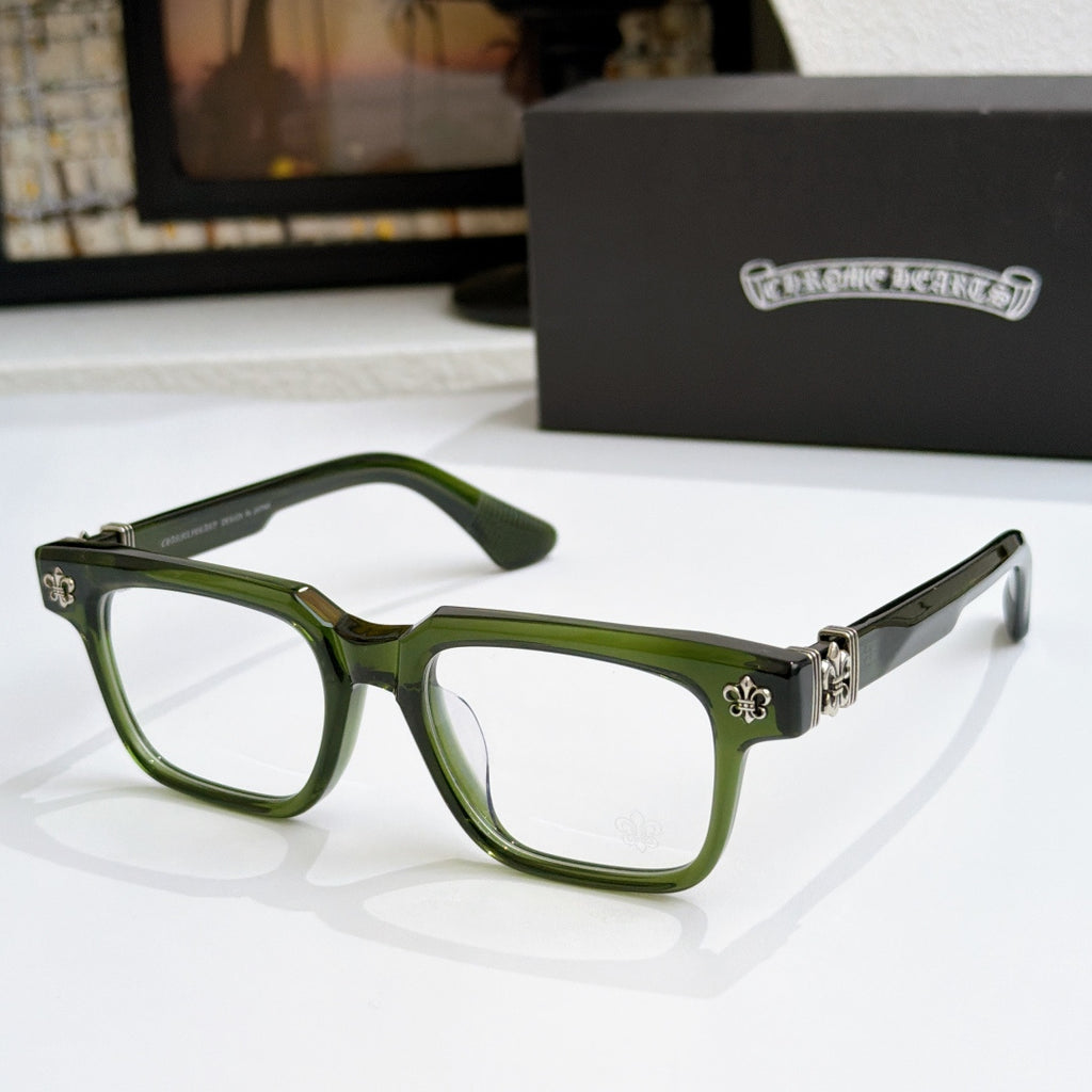 Green frame chrome eyeglasses with gold-tone arms and fleur-de-lis hinge detail