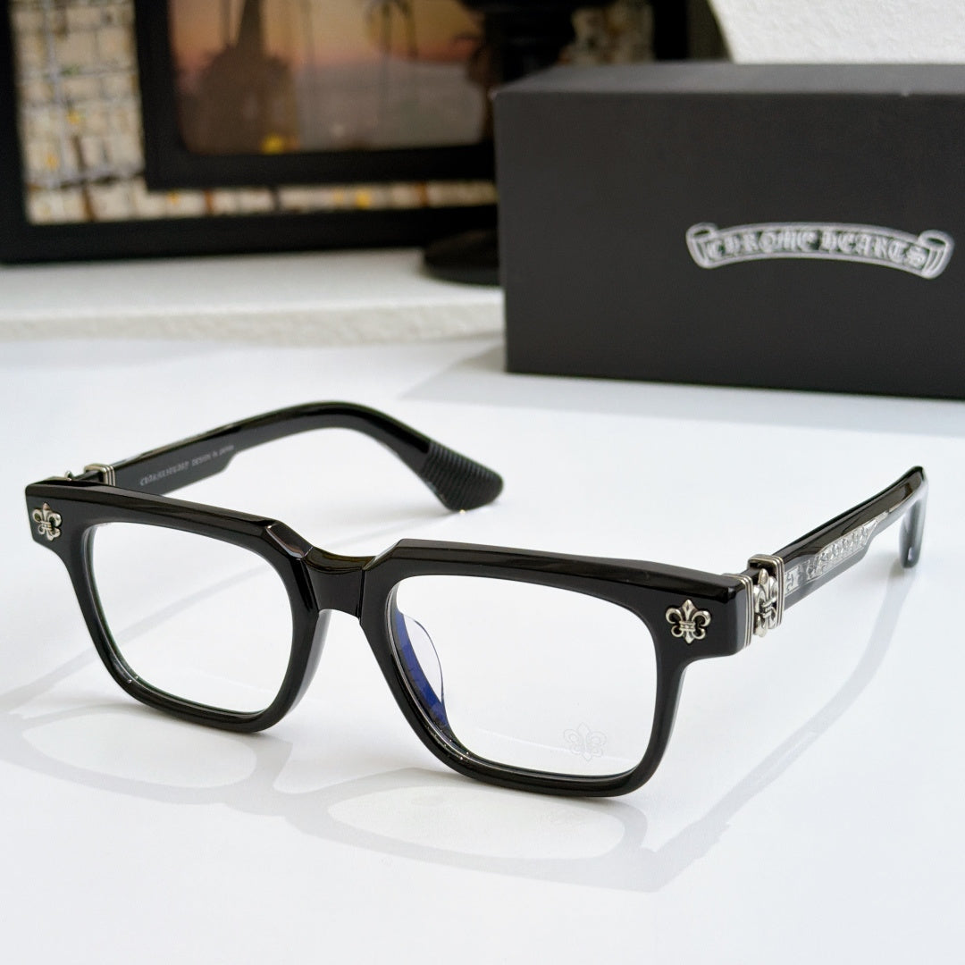 Dark frame chrome eyeglasses with gold-tone arms and blue-tinted lens