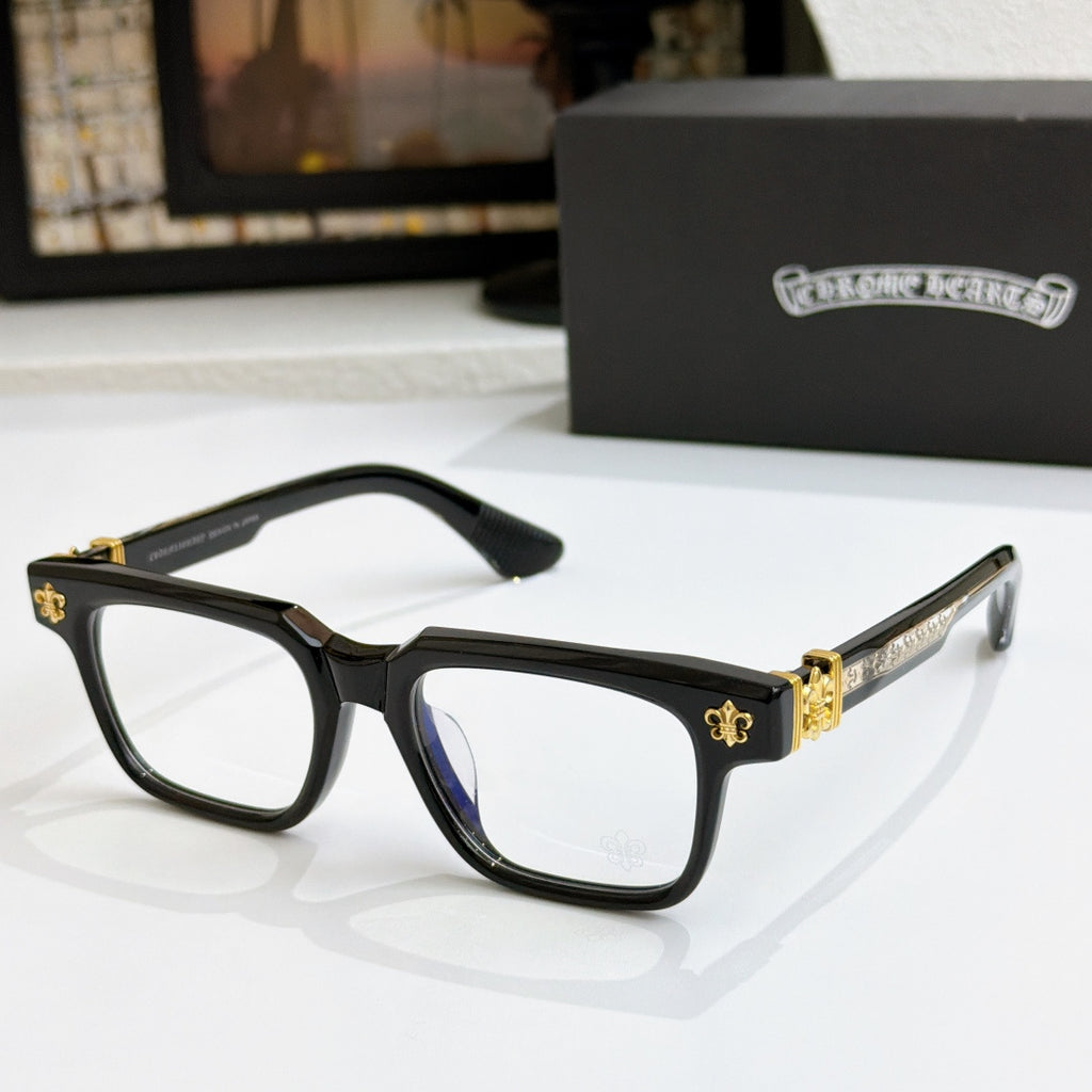 Black frame chrome eyeglasses with gold-tone arms and fleur-de-lis hinge detail