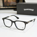 Black eyeglass frames with clear lenses, gold embellishments on temples and bridge