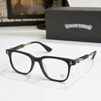 Black eyeglass frames with clear lenses, gold embellishments on temples and bridge