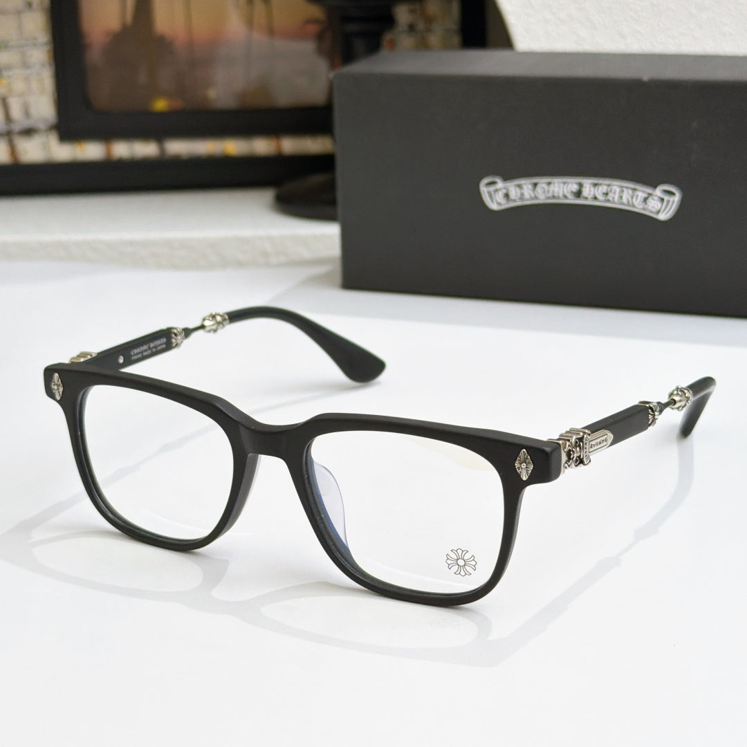 Black eyeglass frames with clear lenses, gold embellishments on temples and bridge