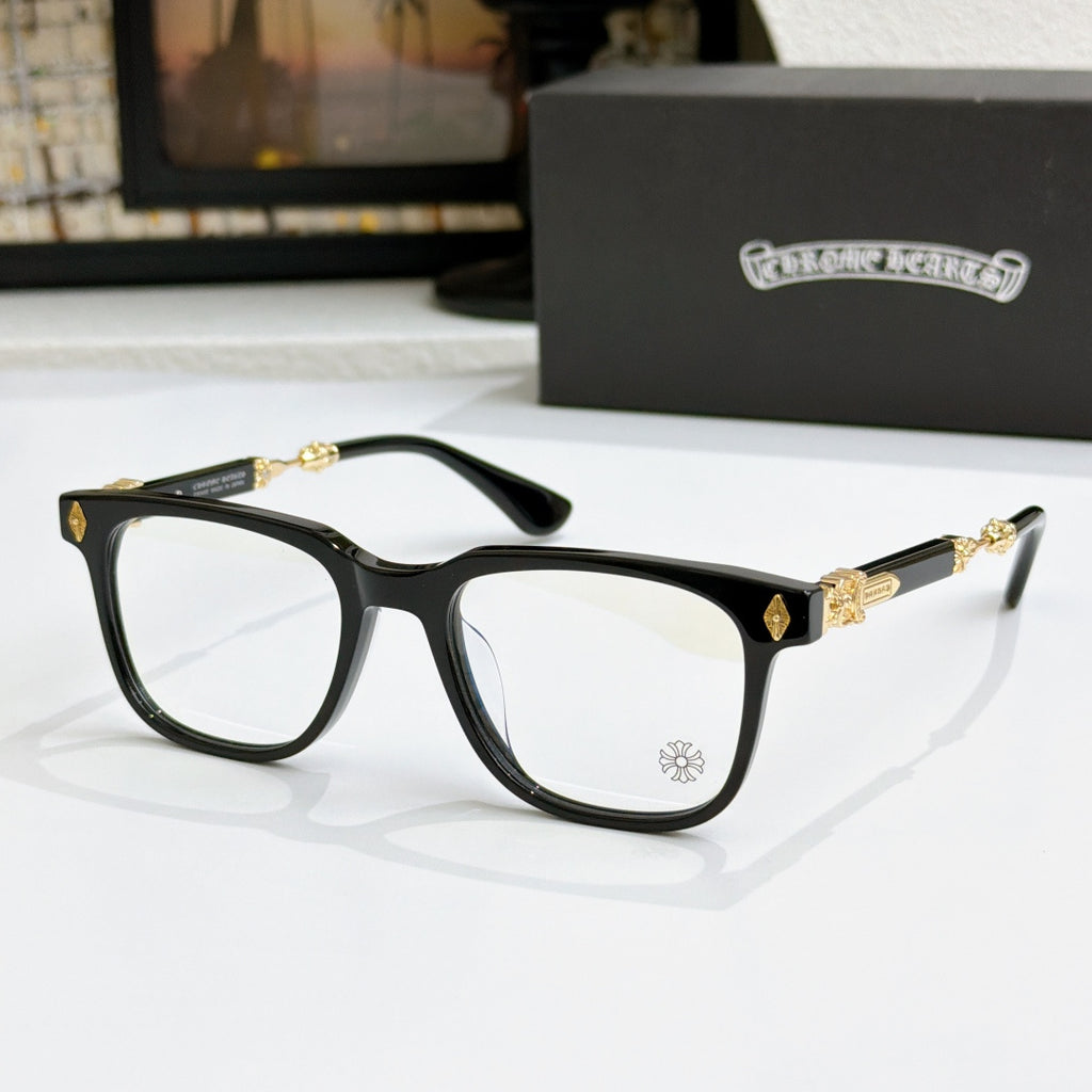 Black eyeglass frames with clear lenses, gold detailing on temples and bridge