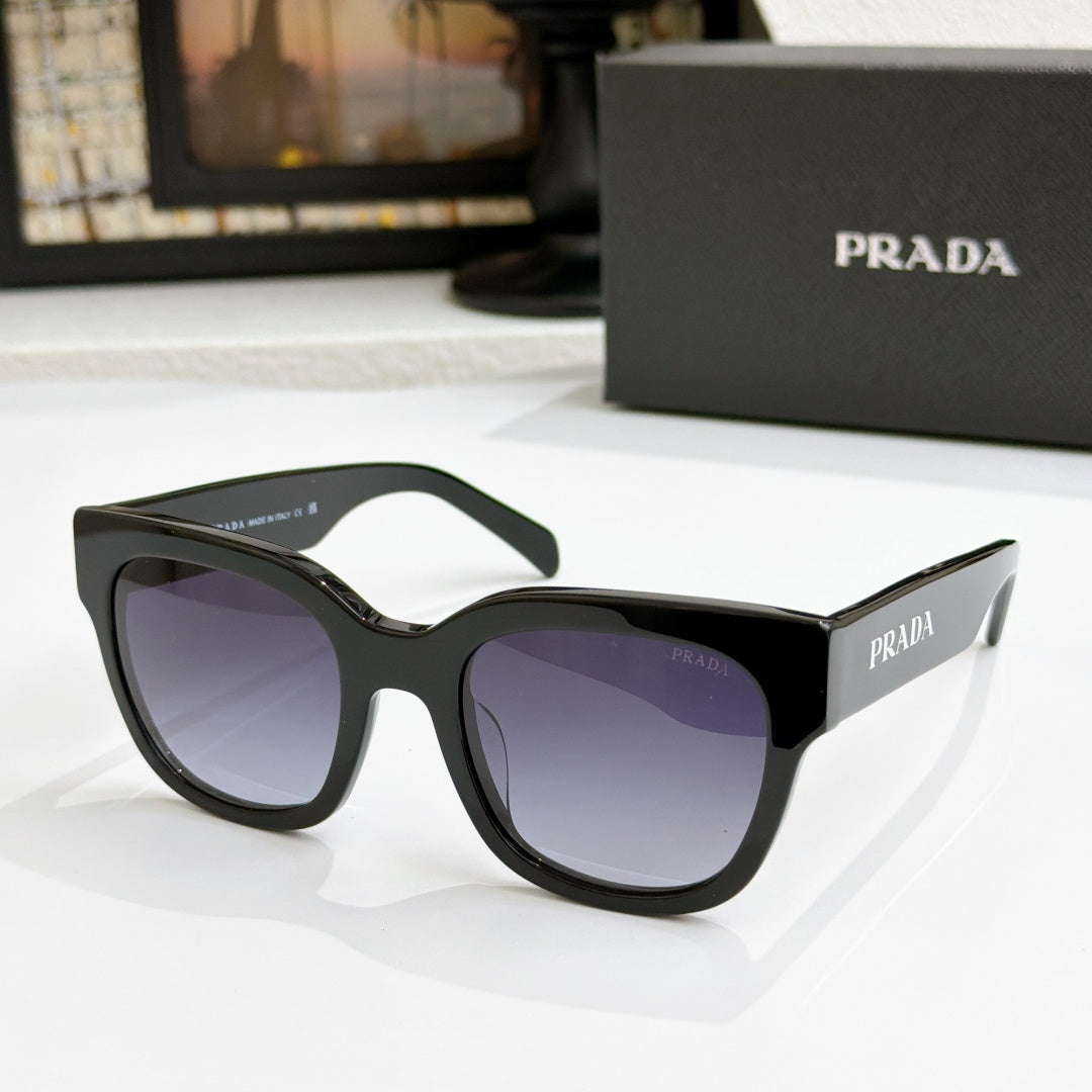 Black sunglasses with purple gradient lenses and PRADA logo at temples