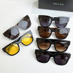 Five pairs of PRADA sunglasses with mixed brown, purple, and yellow lenses