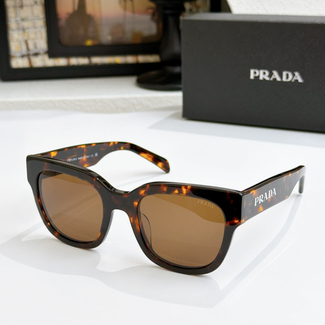 Tortoiseshell sunglasses with brown gradient lenses and dark frame detail