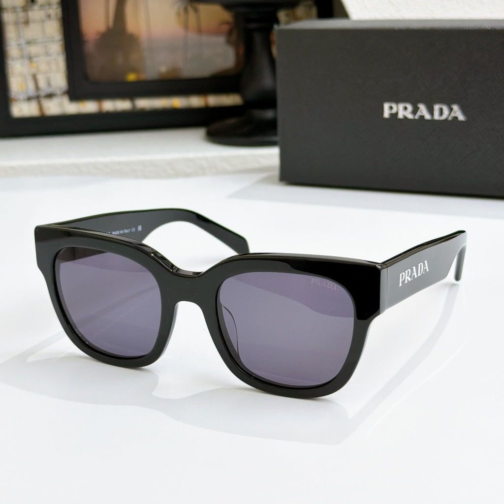 Black sunglasses with purple gradient lenses and PRADA logo on temples