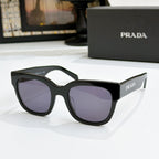 Black sunglasses with purple gradient lenses and PRADA logo on temples
